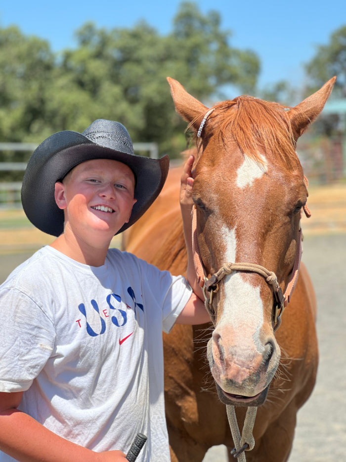 Participant working with a horse during an equine-assisted learning session at Warrior’s Soul
