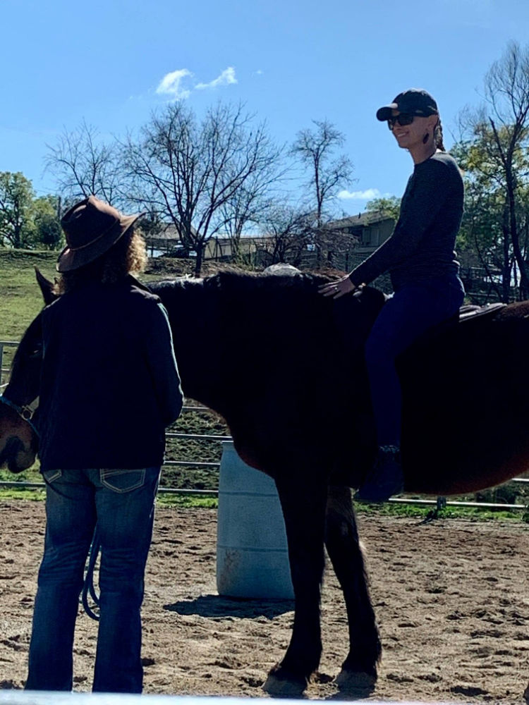 Woman riding a horse during an equine assisted learning and coaching session for women.